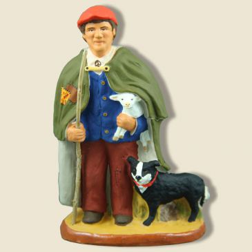 image: Shepherd with lam and dog