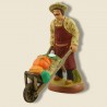 image: Gardener with vegetables on wheelbarrow
