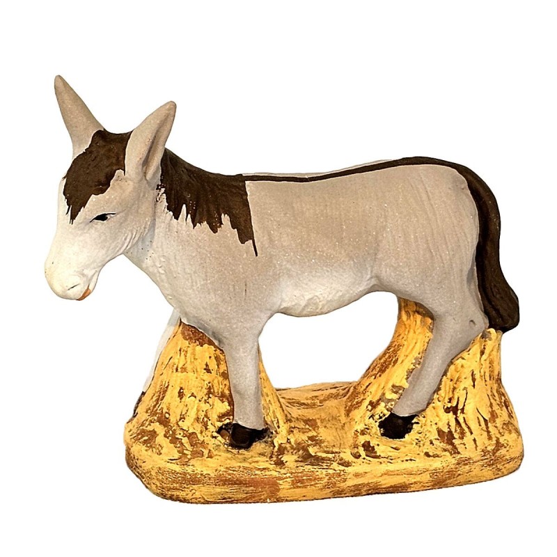 image: Donkey standing on strow
