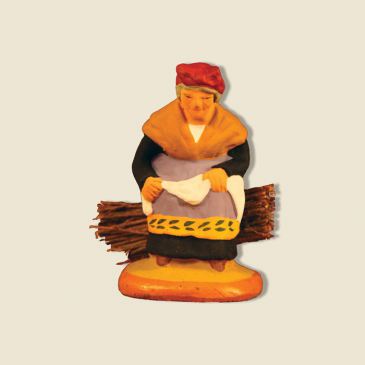 image: Old woman seated on a bundle of firewood
